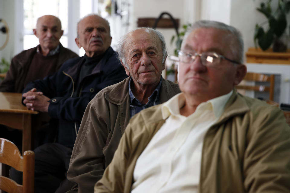 In this Tuesday, May 14, 2019, photo, pensioners sit at a community center for the retired in Karpenisi town at Evrytania region, in central Greece. The area, a winding, three-hour drive from Athens, has the oldest population in the whole European Union, 54.3 on average. (AP Photo/Thanassis Stavrakis)