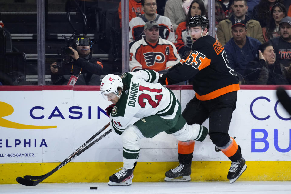 Philadelphia Flyers' Rasmus Ristolainen, right, and Minnesota Wild's Brandon Duhaime collide during the second period of an NHL hockey game, Thursday, March 23, 2023, in Philadelphia. (AP Photo/Matt Slocum)