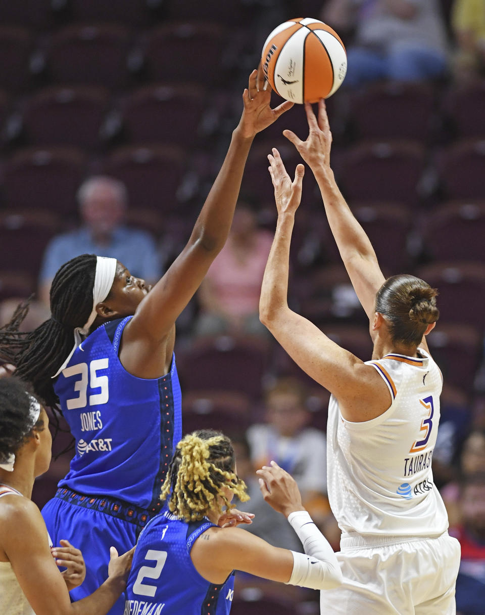 Connecticut Sun forward Jonquel Jones (35) blocks a shot attempt by Phoenix Mercury guard Diana Taurasi (3) during a WNBA basketball game Tuesday, Aug. 2, 2022, in Uncasville, Conn. (Sean D. Elliot/The Day via AP)