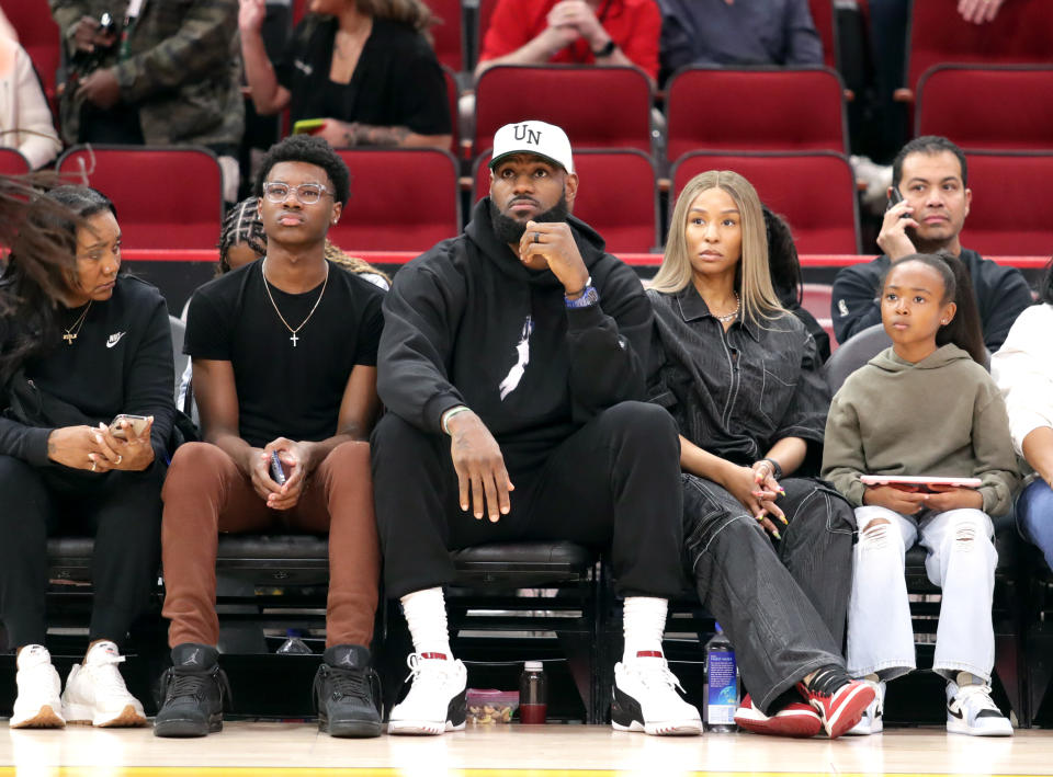 HOUSTON, TEXAS – MARCH 28: LeBron James (C), Savannah James (CR), and guests attend the 46th Annual McDonalds All American Games with Halftime Performance by Don Toliver on March 28, 2023 in Houston, Texas. (Photo by Bob Levey/Getty Images)