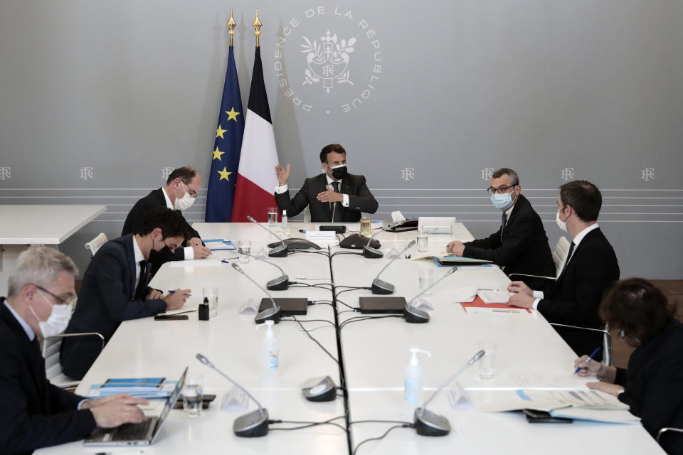 French President Emmanuel Macron, center attends a weekly meeting about the vaccination campaign, with Prime Minister Jean Castex, left, Secretary General of the Elysee Palace Alexis Kohler, right, Government's spokesman Gabriel Attal, second left, Health Minister Olivier Veran, second right, at the Elysee presidential palace in Paris, France, Tuesday April, 20, 2021. (AP Photo/Lewis Joly, pool)