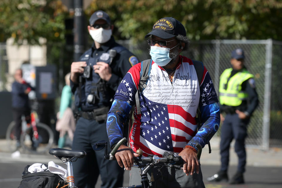 WASHINGTON D.C., UNITED STATES - NOVEMBER 5, 2020: A local man and polics officers in face masks at Black Lives Matter Plaza during a protest at the crossing of I Street NW and 16th Street NW. On November 3, 2020, Americans voted to elected a president and vice president, 35 Senators, all 435 members of the House of Representatives, 13 governors of 11 states and two US territories, as well as state and local government officials. Running for president are incumbent Republican President Trump and Democratic Party nominee Biden. Yegor Aleyev/TASS (Photo by Yegor Aleyev\TASS via Getty Images)