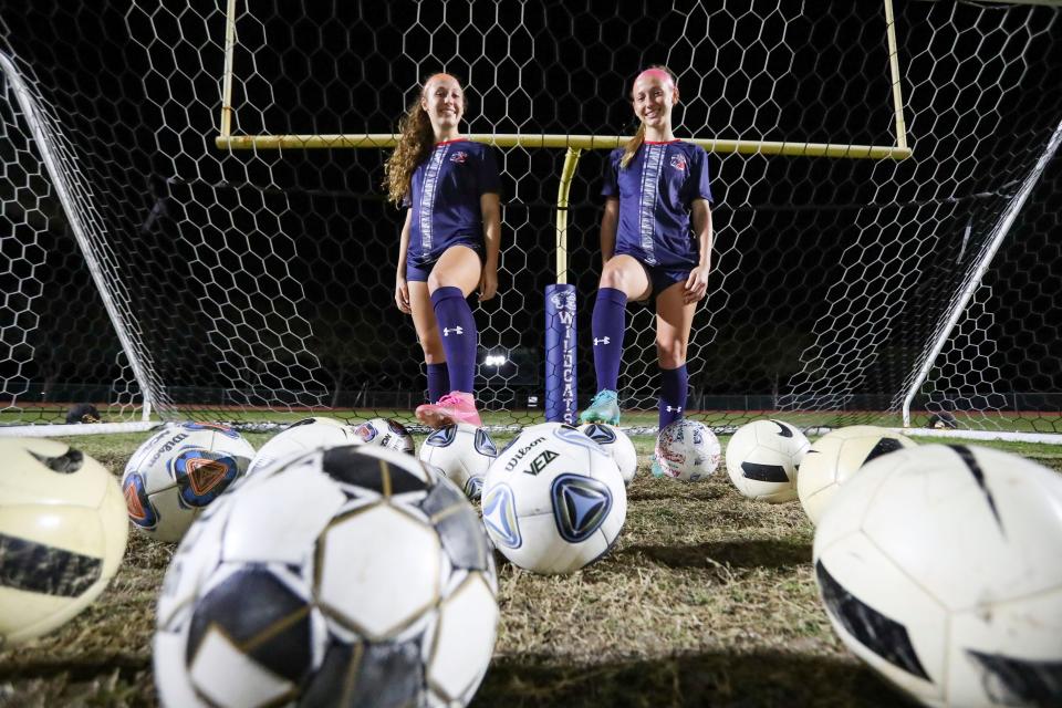 Estero Wildcats sisters Ansley, left, and Kaitlyn Mancini pose for a photo after the Class 4A regional quarterfinal at Jeff Sommer Stadium in Estero on Tuesday, Feb. 7, 2023. 