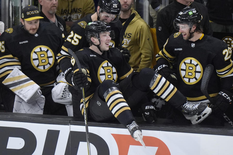 Boston Bruins defenseman Mason Lohrei, center, celebrates with teammates on the bench after scoring in the third period of an NHL hockey game against the Vegas Golden Knights, Thursday, Feb. 29, 2024, in Boston. (AP Photo/Steven Senne)