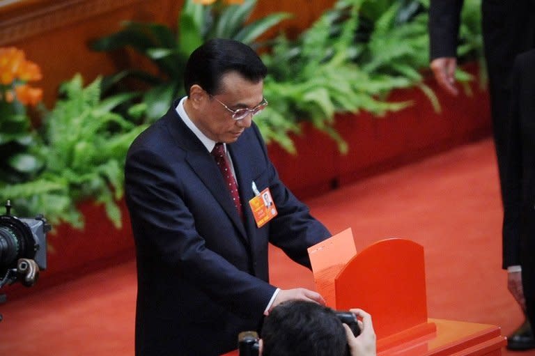 Li Keqiang casts his vote for the election for the new president of China during the 12th National People's Congress in the Great Hall of the People in Beijing, on March 14, 2013. China's parliament named Li to the post of premier on Friday, a role that involves running day-to-day government in the world's second-largest economy