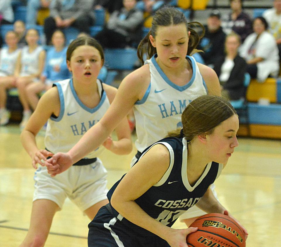 Hamlin sisters Paxton (left) and Addison Neuendorf pressure Sioux Valley's Talya Vincent during their high school girls basketball game on Monday, Feb. 5, 2024 at the Hamlin Education Center.