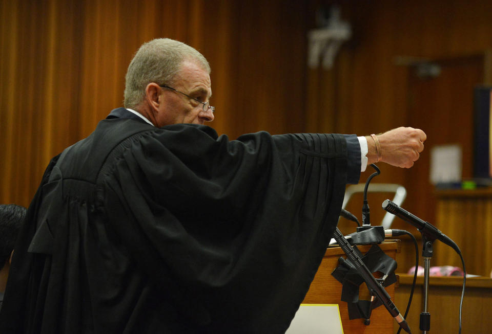 South African chief state prosecutor Gerrie Nel gestures as he explains a possible scenario into how Oscar Pistorius might have fired on girlfriend Reeva Steenkamp, in court in Pretoria, South Africa, Monday, April 14, 2014. A judge temporarily adjourned the murder trial of Oscar Pistorius after the athlete started to sob while testifying about the moments before he killed girlfriend Reeva Steenkamp in his home last year. (AP Photo/Antoine de Ras, Pool)