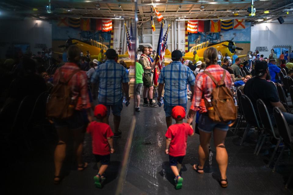 People gather in a hangar aboard the USS Lexington for a Memorial Day wreath laying on Monday, May 30, 2022.