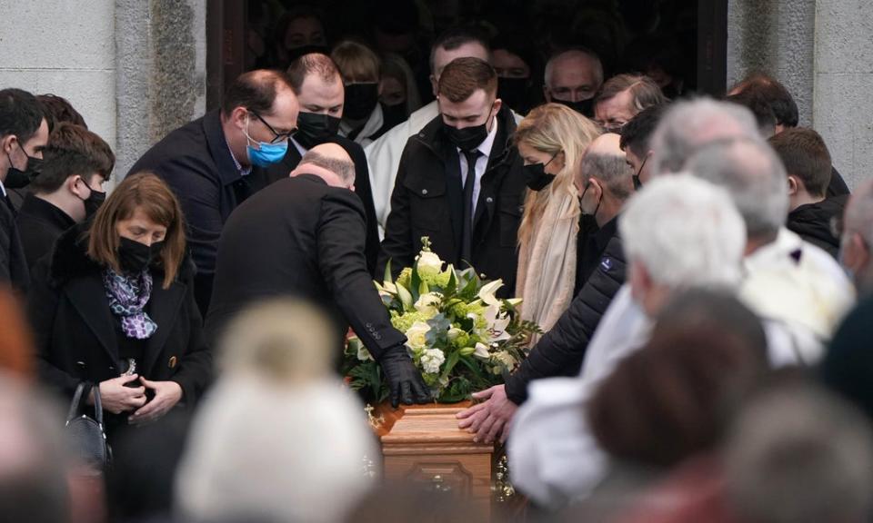 Family members place their hands on the coffin as it is carried out of St Brigid’s Church, Mountbolus, Co Offaly (Niall Carson/PA) (PA Wire)