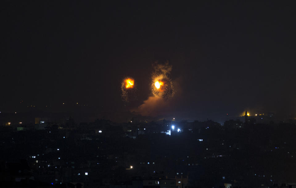 Fire balls caused by Israeli airstrikes on Gaza City, early Thursday, Aug. 9, 2018. Israel struck targets in the Gaza Strip after dozens of rockets were launched Wednesday from the coastal territory ruled by the Islamic militant Hamas group, the Israeli military said.(AP Photo/Khalil Hamra)