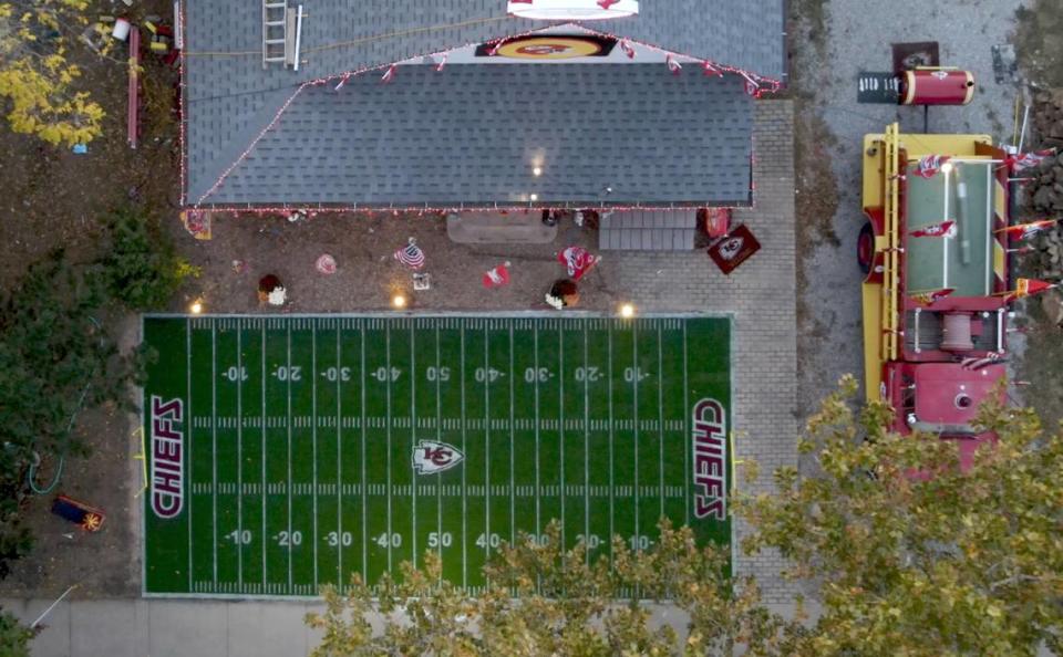 Dennis Basye made this field using a 3-D stencil he created to meticulously lay down the yard lines and Chiefs logo. At right is his 1965 firetruck that is emblazoned in Chiefs’ logos.