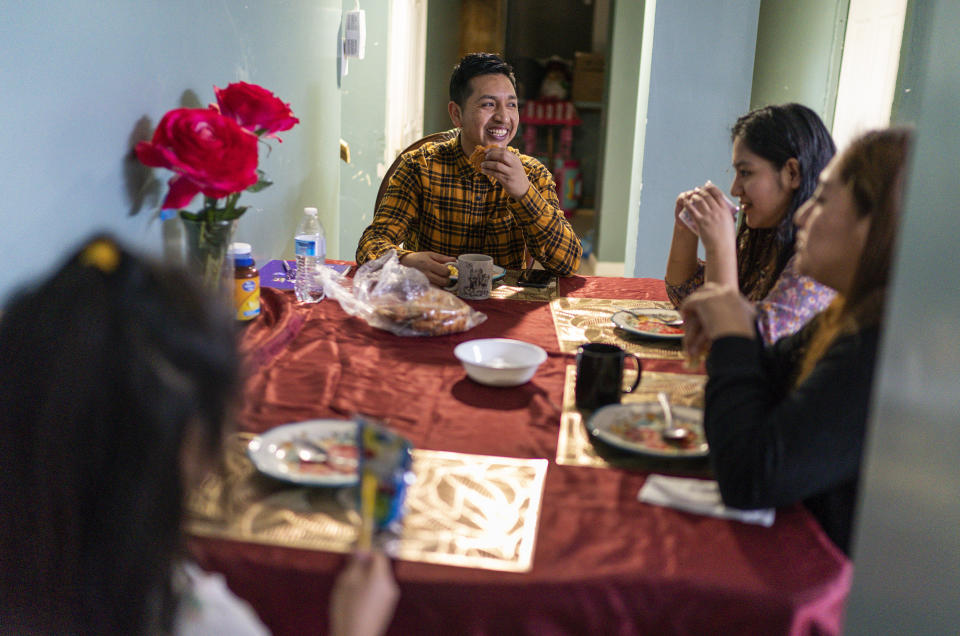 Ecuadorian migrant Klever Ortega, left, eats breakfast with his wife, Cristina Lema, far right, and daughters, Saturday, March. 3, 2023, in Spring Valley, N.Y. Ecuador — long known for remarkably low rates of crime, despite sitting in South America's cocaine heartland — has been struggling economically, fighting higher violence and losing its people in record numbers. Like Ortega and Lema, many are headed to the U.S.(AP Photo/Eduardo Munoz Alvarez)