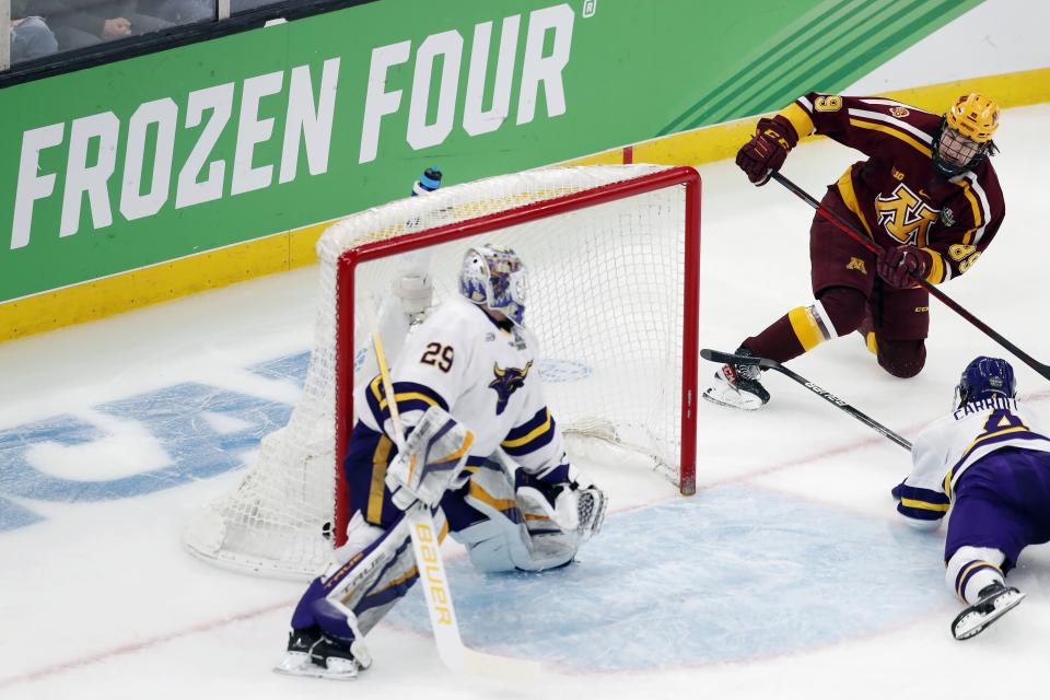 Minnesota's Matthew Knies (89) scores on Minnesota State's Dryden McKay (29) during the first period of an NCAA men's Frozen Four college hockey semifinal Thursday, April 7, 2022, in Boston. (AP Photo/Michael Dwyer)
