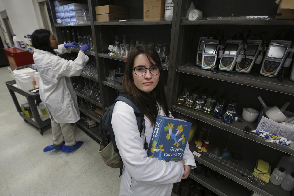 Ricki Korba, 23, stands for a portrait in her lab at California State University, Bakersfield in Bakersfield, Calif., on Friday, April 14, 2023. Facing an extra year of school, Korba likely will run out of financial aid before she graduates. She’s making plans to go part-time in school and work longer hours so she can afford tuition and rent. But she wonders how long she can juggle it all. (AP Photo/Gary Kazanjian)