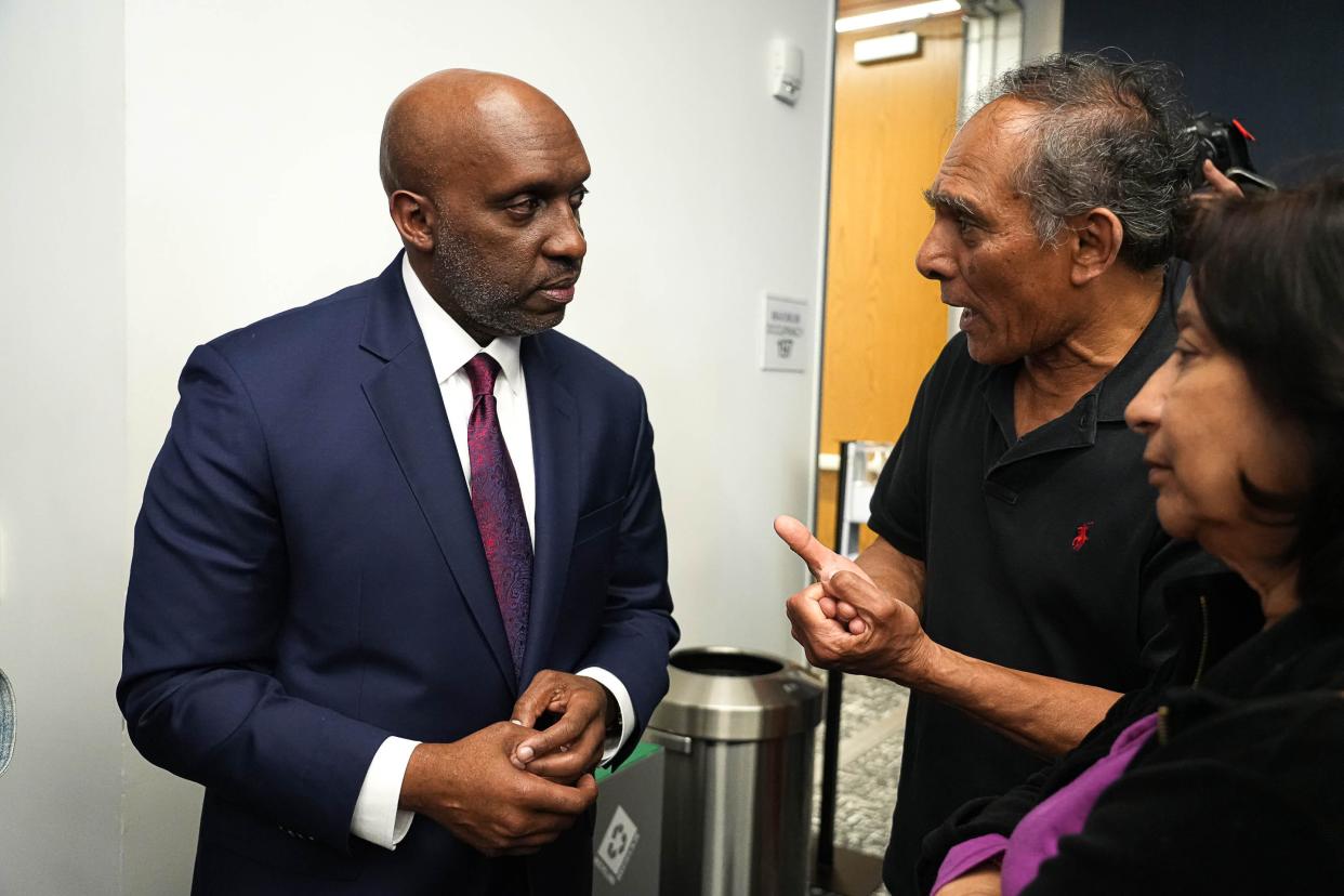 T.C. Broadnax Jr., candidate for Austin City Manager and current City Manager of Dallas, Texas, listens to Suit DasGupta, center, and Debasree DasGupta, right, after an open town hall at the Permitting and Development Center on Monday, March 25, 2024in Austin.