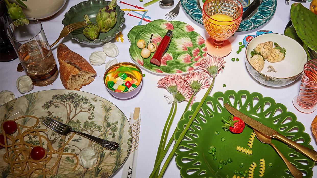 a table with plates and food in various colors and shapes