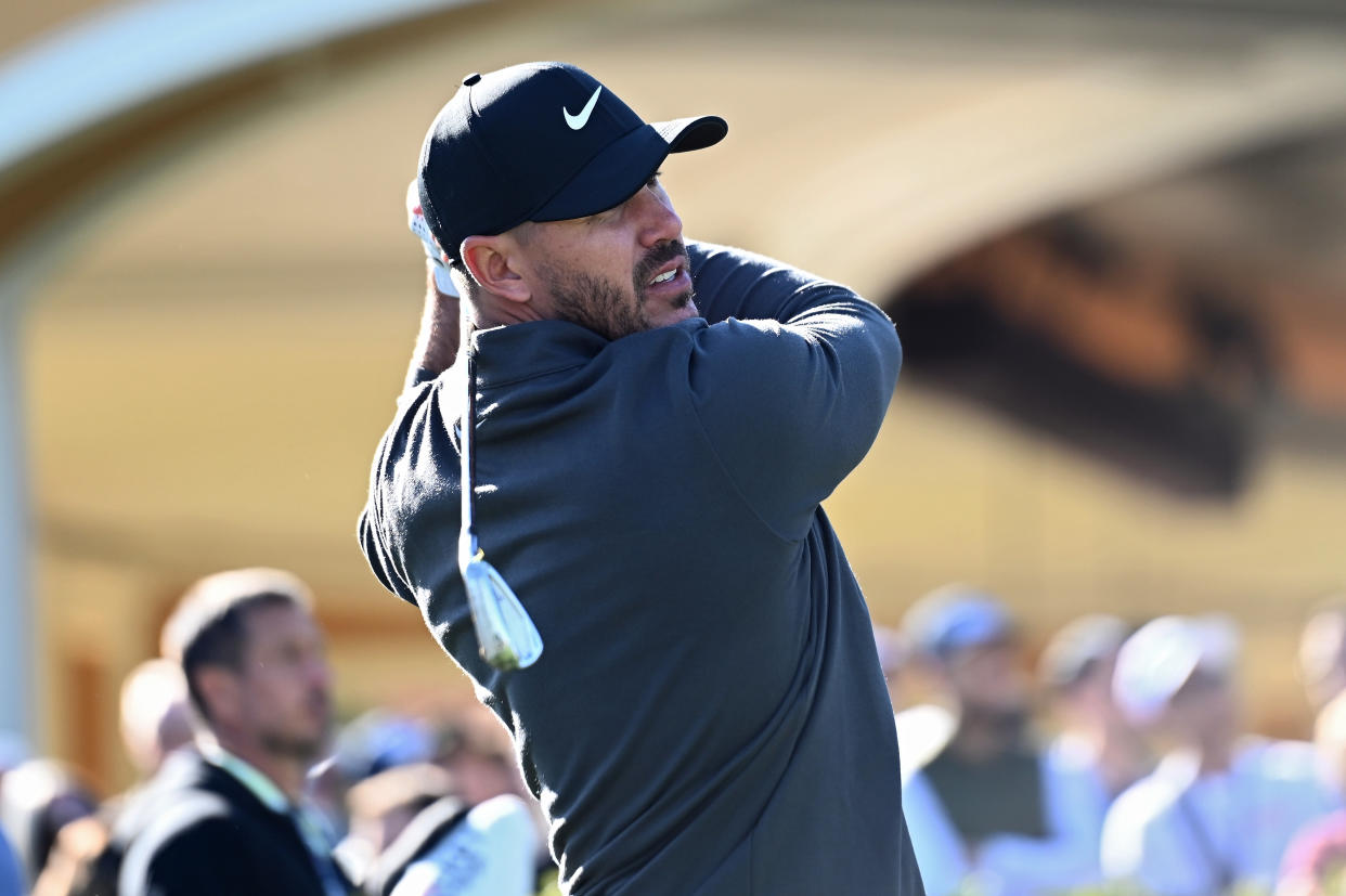 Brooks Koepka warms up on the driving range during Capital One's The Match