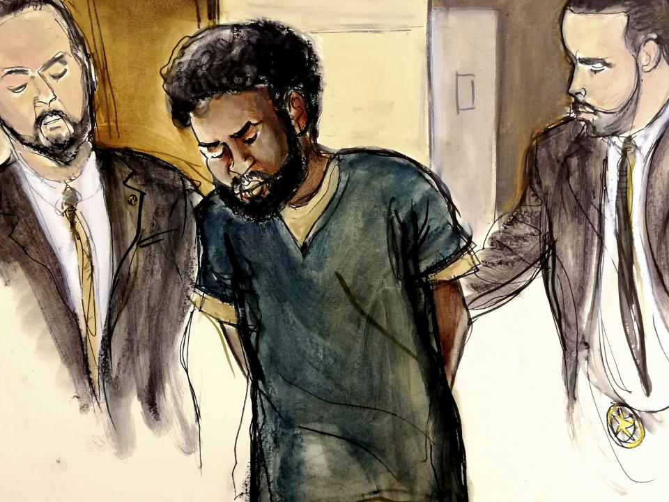 FILE - In this Jan. 11, 2018 court room file drawing, U.S. Marshals escort defendant Akayed Ullah, center, into court in New York for his arraignment on charges of setting off a pipe bomb in New York City's busiest subway station at rush hour last Dec. 11. A guilty verdict against the Bangladeshi immigrant was returned on Tuesday, Nov. 6, 2018, in Manhattan federal court.(Elizabeth Williams via AP, File)