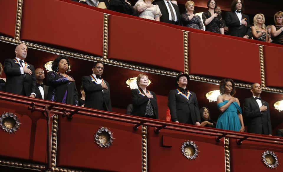 Kennedy Center Honors recipients stand for the national anthem with U.S. President Barack Obama and first lady Michelle Obama at the Kennedy Center in Washington