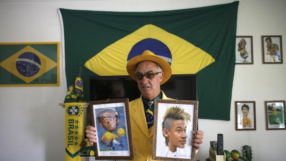 Brazilian attorney, Nelson Paviotti, holds up caricatures of his soccer idols in Campinas