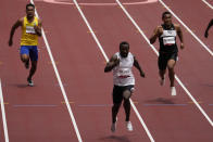 Dorian Keletela, of Refugee Olympic Team, wins a heat in the men's 100-meter run at the 2020 Summer Olympics, Saturday, July 31, 2021, in Tokyo. (AP Photo/Charlie Riedel)