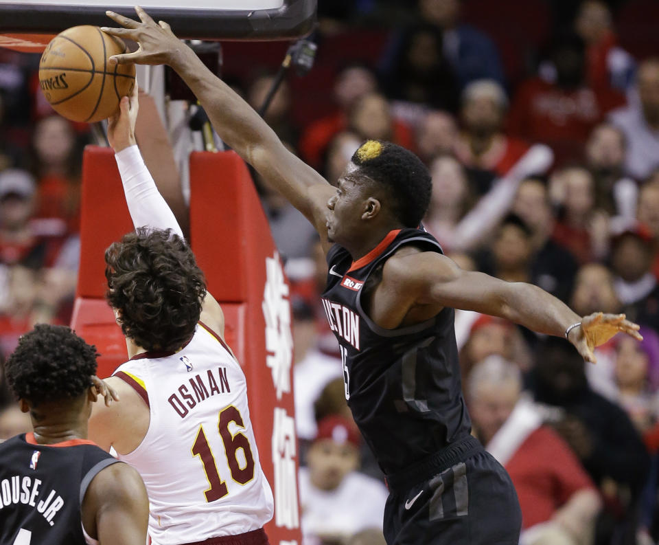 Houston Rockets center Clint Capela, right, blocks the shot of Cleveland Cavaliers forward Cedi Osman (16) during the first half of an NBA basketball game Friday, Jan. 11, 2019, in Houston. (AP Photo/Eric Christian Smith)