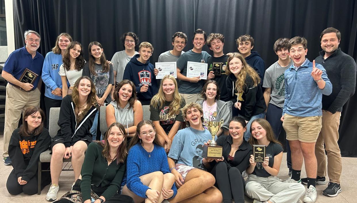 The Savannah Country Day School's theater department, led by James Venhaus (far left, background), pose with their award for the division III schools Georgia High School Association state championship.