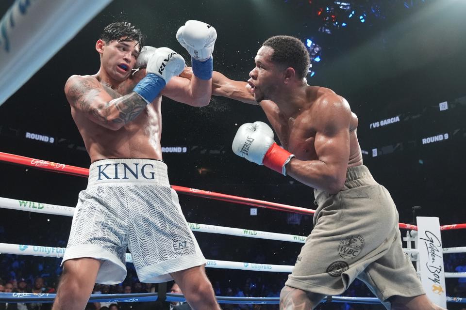 Devin Haney, right, punches Ryan Garcia during the ninth round of a super lightweight boxing match early Sunday, April 21, 2024, in New York. Garcia won the fight. (AP Photo/Frank Franklin II)