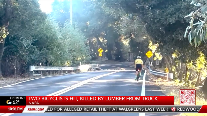Screenshot of the news report of two cyclists being killed showing a different cyclist riding along the winding two-lane road