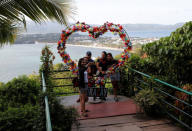 Resort workers who were cut-off from their jobs take a "selfie" in Mount Luho viewpoint in the holiday island of Boracay, in Philippines April 26, 2018. REUTERS/Erik De Castro