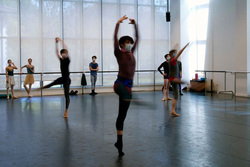 Shanghai Ballet dancers wearing masks practise in a dance studio in Shanghai