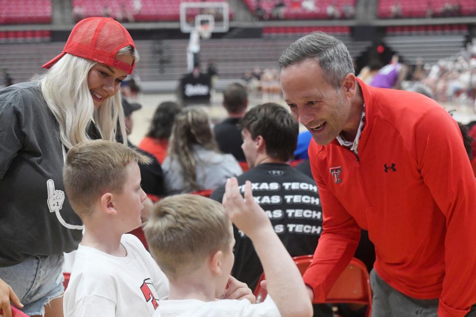 Texas Tech men's basketball coach Grant McCasland high-fives fans during the Air Raiders game against the Purple Hearts at the first round of The Basketball Tournament Lubbock Regional, Wednesday, July 19, 2023, at United Supermarkets Arena.