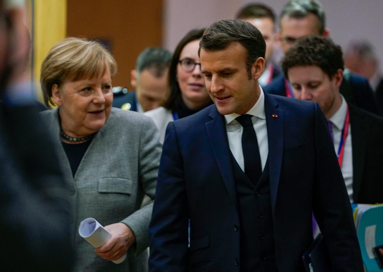 Germany's Chancellor Angela Merkel (L) and France's President Emmanuel Macron speak as they walk after a bi-lateral meeting on the second day of a special European Council summit in Brussels on February 21, 2020, held to discuss the next long-term budget of the European Union (EU). (Photo by kenzo tribouillard / POOL / AFP) (Photo by KENZO TRIBOUILLARD/POOL/AFP via Getty Images)