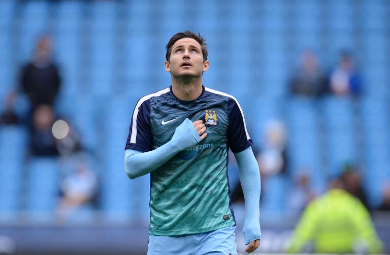 Manchester City's English midfielder Frank Lampard warms up on the pitch ahead of the English Premier League football match between Manchester City and Queens Park Rangers in Manchester, England, on May 10, 2015