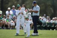 Byeong Hun An, of South Korea, watches his son Sunwoo hit on the first hole during the par-3 contest at the Masters golf tournament at Augusta National Golf Club Wednesday, April 10, 2024, in Augusta, GA. (AP Photo/Ashley Landis)