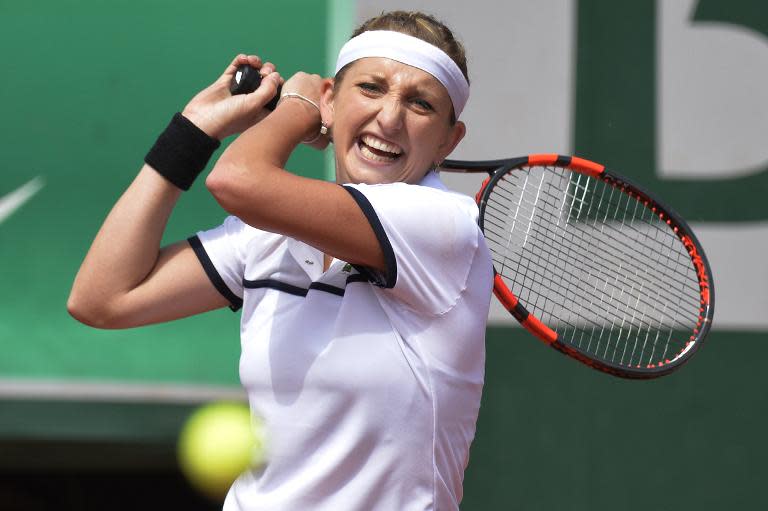 Switzerland's Timea Bacsinszky returns the ball to Belgium's Alison Van Uytvanck during the women's quarter-finals of the Roland Garros 2015 French Open in Paris on June 3, 2015