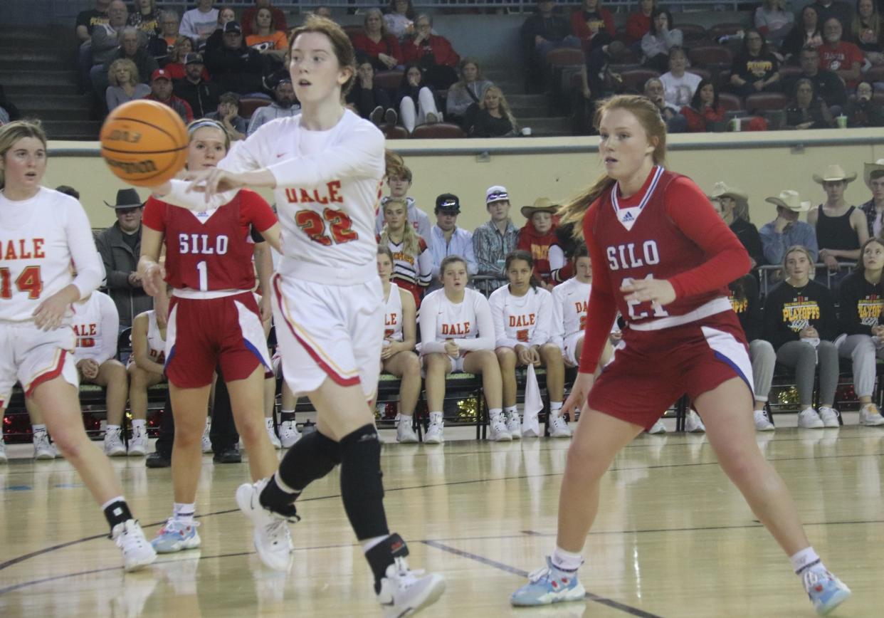 Dale's Brook Rutland (22) dishes off a pass to a teammate Thursday morning during the first round of the Class 2A Girls State Basketball Tournament at the State Fairgrounds Arena in Oklahoma City.