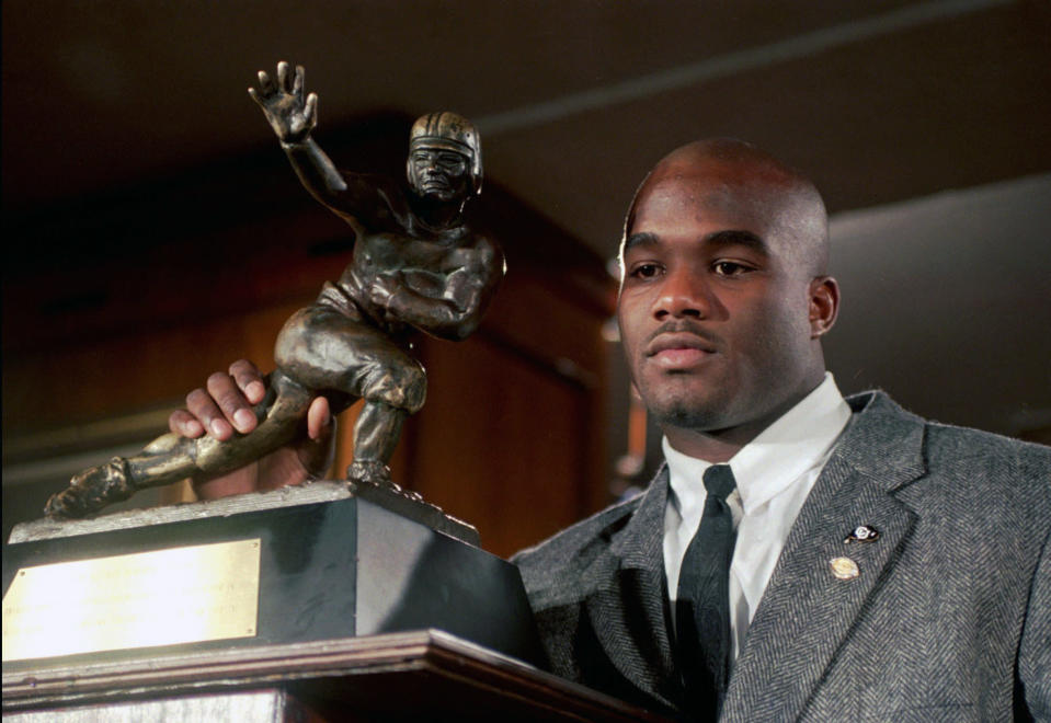 FILE – In this Dec. 10, 1994, file photo, Colorado’s Rashaan Salaam poses with his Heisman Trophy at the Downtown Athletic Club in New York. (AP Photo/Adam Nadel, File)