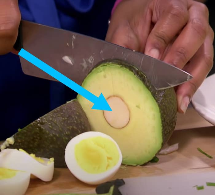 Contestant on "Worst Cooks In America" cutting through an avocado pit