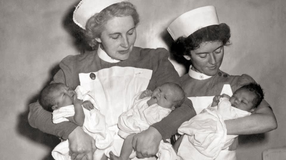 Nurses cradle the first babies to be born under the new National Health Service on 5th July 1948. Had they been born a day earlier, they would have cost their families one shilling and sixpence, according to new book "The National Health Service." - PA Images / Alamy Stock Photo