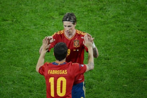 Spanish forward Fernando Torres is congratulated by Spanish midfielder Cesc Fabregas after scoring during the Euro 2012 championships football match Spain vs Republic of Ireland at the Gdansk Arena. A double by Torres inspired defending champions Spain to a 4-0 thrashing of Ireland