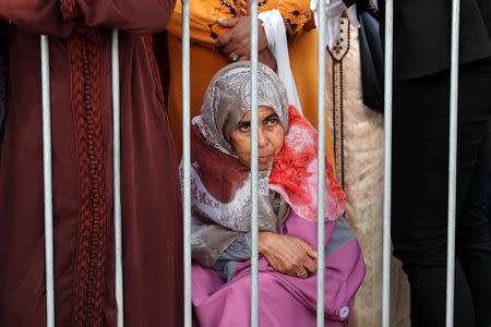 A woman watches as Pope Francis and King Mohammed VI of Morocco visit the Mohammed VI Institute for the Training of Imams Morchidines and Morchidates in Rabat, Morocco, March 30, 2019. REUTERS/Remo Casilli