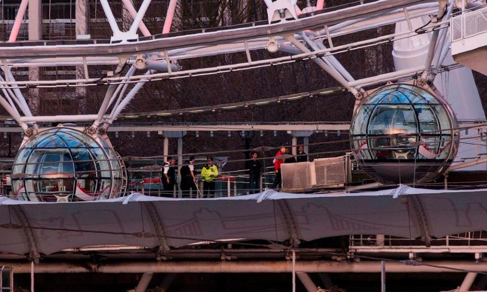 Tourists being evacuated from London Eye pods by police.