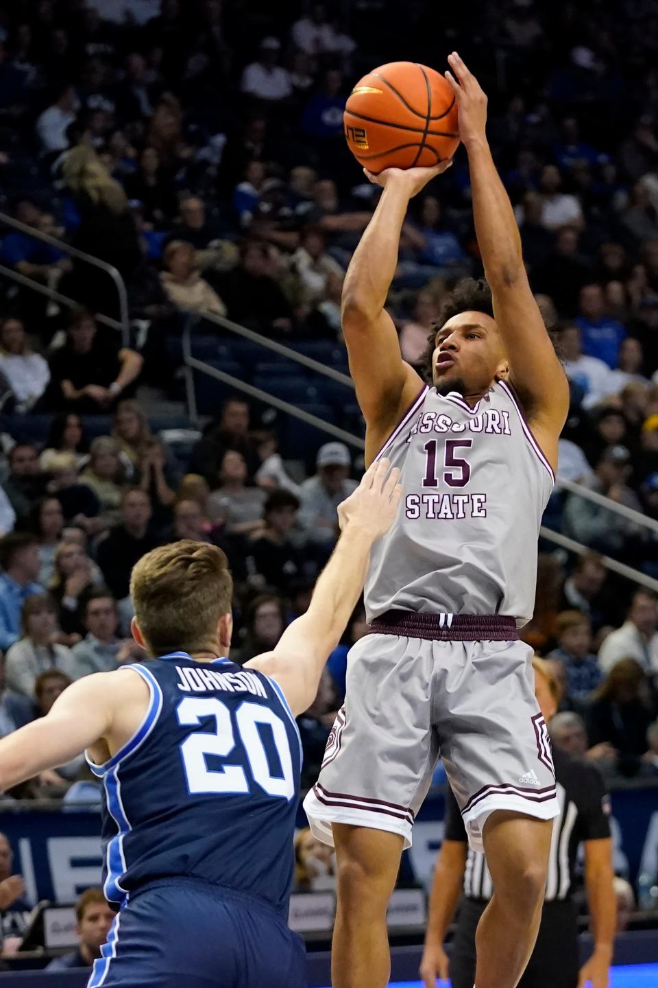 Missouri State guard Matthew Lee (15) shoots as BYU guard Spencer Johnson (20) defends during the first half of an NCAA college basketball game Wednesday, Nov. 16, 2022, in Provo, Utah. (AP Photo/Rick Bowmer)