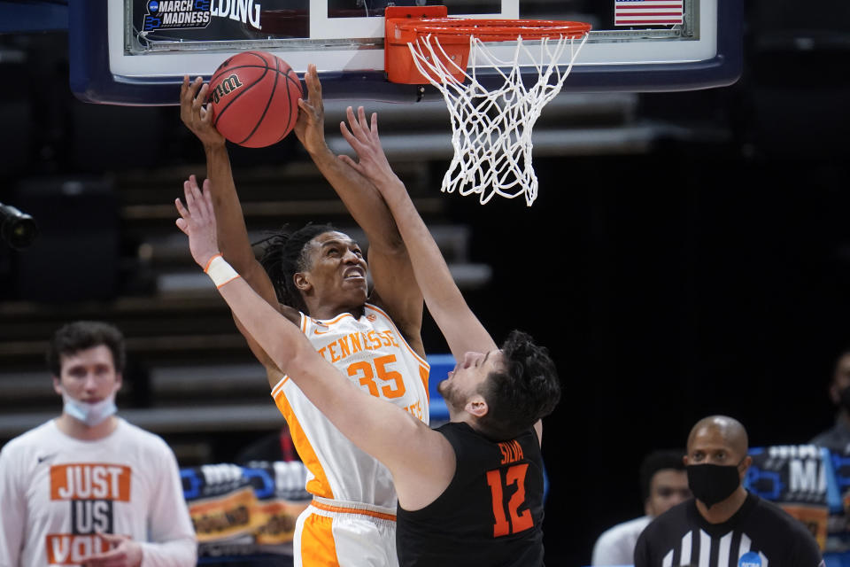 Oregon State center Roman Silva (12) defends Tennessee guard Yves Pons (35) during the second half of a men's college basketball game in the first round of the NCAA tournament at Bankers Life Fieldhouse in Indianapolis, Friday, March 19, 2021. (AP Photo/Paul Sancya)