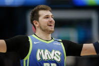 Dallas Mavericks forward Luka Doncic celebrates during a timeout in the second half of the team's NBA basketball game against the Portland Trail Blazers, Friday, Jan. 17, 2020, in Dallas. The Mavericks won 120-112. (AP Photo/Brandon Wade)