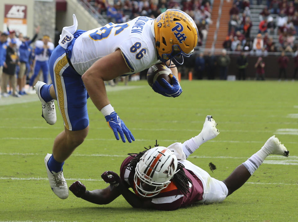 Pittsburgh's Gavin Bartholomew (86) scores a touchdown past Virginia Tech defensive back Nasir Peoples (31) in the first half of an NCAA college football game, Saturday, Oct. 16, 2021, in Blacksburg, Va. (Matt Gentry/The Roanoke Times via AP)