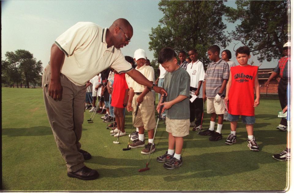 A group of children are learning the game of golf at the Belle Isle Driving Range in June 1999.