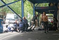 Members of the public watch as police and emergency services attend to an injured person after a car hit pedestrians in central Melbourne, Australia, January 20, 2017. AAP/Luke Costin/via REUTERS