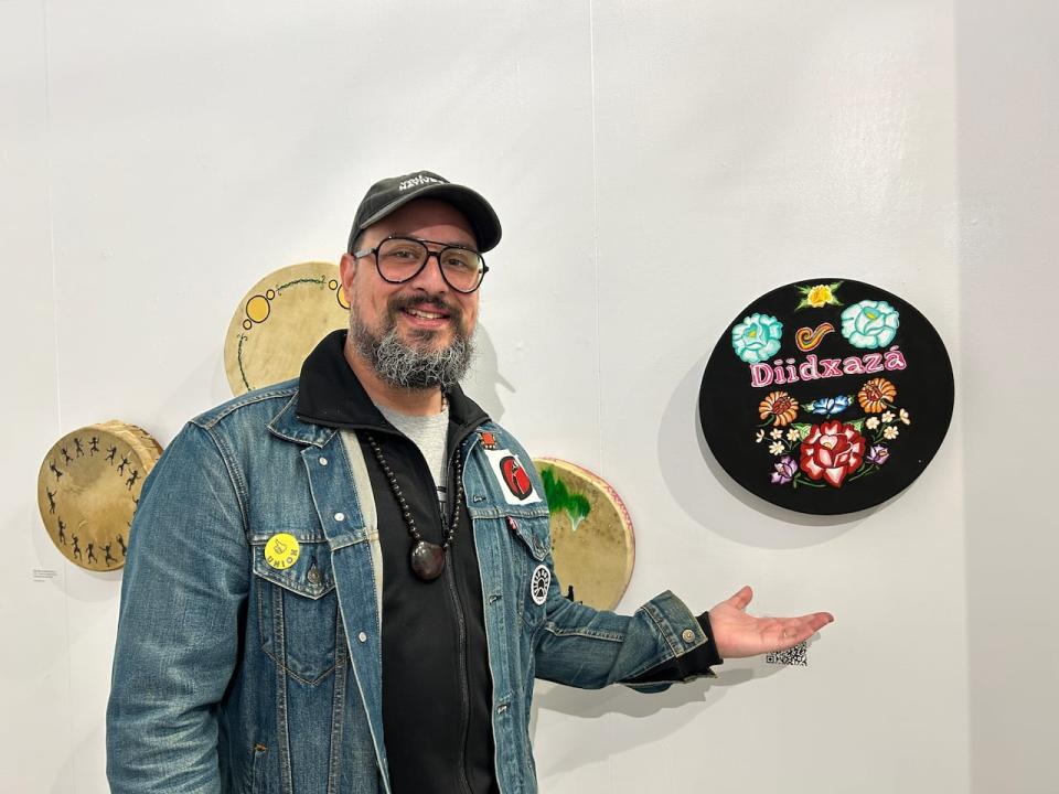 Artist Dr. Joshua Schwab-Cartas pictured here with his drum 'Guie' saa' created by him and his daughter, Najeli Schwab Nicolantonakis. This drum translates to flower celebration and celebrates their language by using designs that are part of the women's regalia amongst Isthmus Binniza's (Zapotec) 